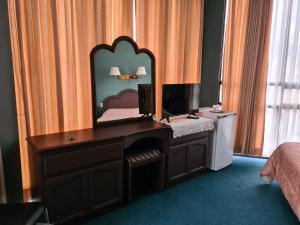 a bedroom with a desk with a mirror on it at Glorieta Hotel in Sucre