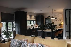 a living room with a couch and a kitchen at Mary's Lane in Randalstown