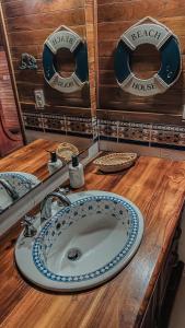 a bathroom counter with a sink and two plates on it at Múcura Club Hotel in Isla Mucura
