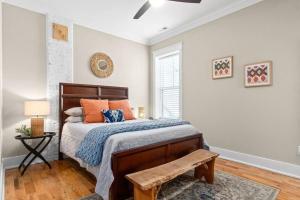 1 dormitorio con 1 cama con almohadas de color naranja en Luxury Historic Condo 3 Mins From Downtown Commons, en Clarksville