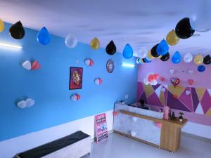 a room with a blue wall with lots of decorations at OYO Green Villa in Meerut