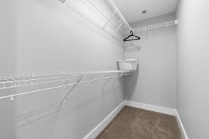an empty room with white walls and white shelves at Upscale Downtown Condo W Outdoor Patio And Parking in Clarksville