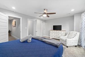 a bedroom with a blue bed and a chair at Upscale Downtown Condo W Outdoor Patio And Parking in Clarksville