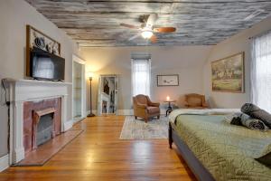 a bedroom with a bed and a fireplace at Historic Condo 2,5 Blocks From Fm Bank Arena in Clarksville