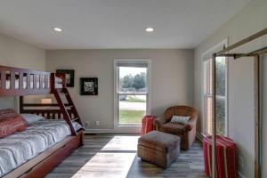 a bedroom with a bed and a chair with luggage at The Residence at Hilltop Acres - Clarksville, TN (1335 Whitt Ln) in Clarksville