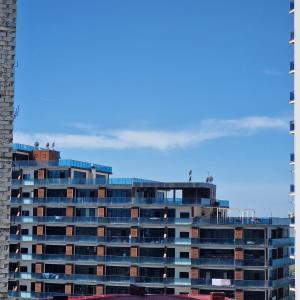 a tall building with people on top of it at Salami Residence in Batumi