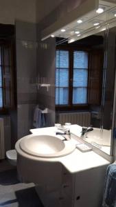 a bathroom with a sink and a mirror at Casa in Borgo Medievale in Toscana in Monterone