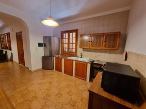 a kitchen with wooden cabinets and a tv in it at Villa Pina Arenella in Arenella +18 photos