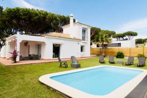 einen Hof mit einem Pool und einem Haus in der Unterkunft Villa Alemania Chalet Independiente con Piscina en Urbanización Roche Conil Cádiz Andalucía España in Roche