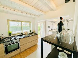 a kitchen with a stove and a counter with vases at Plemmirio Apartments in Siracusa