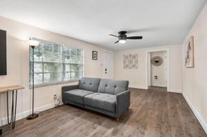 a living room with a couch and a ceiling fan at Westshore Stadium House in Tampa