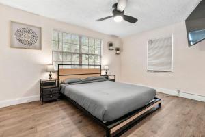 a bedroom with a bed and a ceiling fan at Westshore Stadium House in Tampa