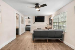 a living room with a couch and a flat screen tv at Westshore Stadium House in Tampa