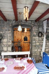 a dining room with a table and a chandelier at Best Location Old Town Budva Rooms in Budva