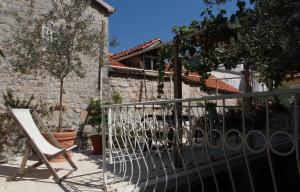 a white chair sitting on a porch next to a building at Best Location Old Town Budva Rooms in Budva