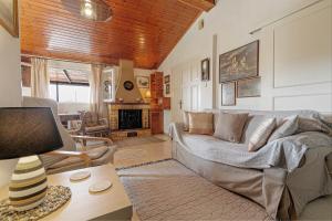 a living room with a couch and a fireplace at Eutuxia House in Corfu Town