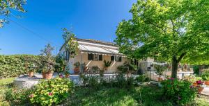 a house with a garden in front of it at Eutuxia House in Corfu