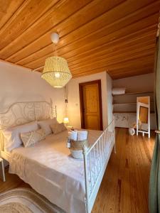 a bedroom with a large bed with a wooden ceiling at Hanole Guest House in Ayvalık