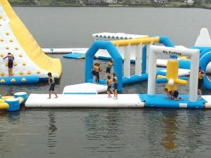 a group of children playing on an inflatable water park at Church Street Cottage in Rosscarbery