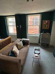 a living room with a couch and a table at John Street Apartment 3 in Bristol