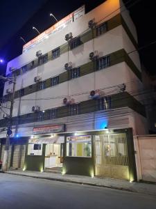 a large building with a gate in front of it at Pousada M&atilde;e Ternura palace in Aparecida