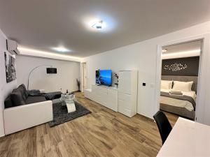 a living room with a couch and a bed at HILLSIDE Apartment Volosko in Opatija