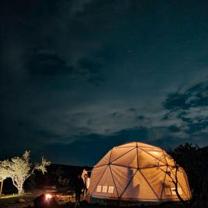 a large dome tent is lit up at night at Mars Glam Camp in Aguascalientes