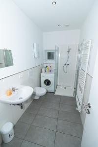 a bathroom with a sink and a toilet and a shower at Kapitän-Dallmann-Str in Bremen