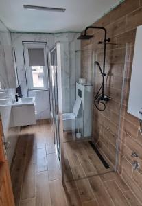a bathroom with a shower and a toilet and a sink at Ubytovanie Topoľčany in Topoľčany