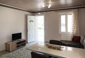 a living room with a couch and a table at Nafsika House in Ayios Kirikos