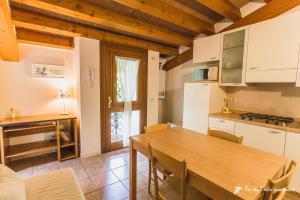 a kitchen and dining room with a wooden table at Ca' degli Ulivi in Creazzo