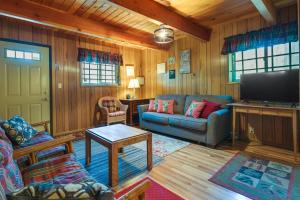 a living room with a couch and a flat screen tv at California Retreat Near Yosemite National Park! in Twain Harte