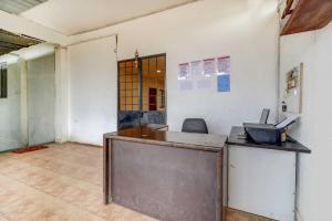 an empty office with a counter in a room at Hotel O Sai Residency in Pune