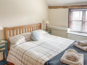 a bedroom with a bed with two towels on it at Easterley Uk31585 in Clifford