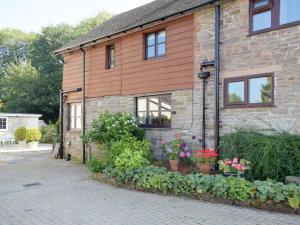 a brick house with flowers in front of it at Easterley Uk31585 in Clifford