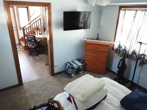 a bedroom with a bed and a desk and a television at Rr-gull Lake Baby House in June Lake