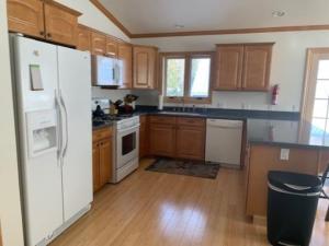 a kitchen with a white refrigerator and wooden cabinets at Rr-johnson Suite 2 in June Lake