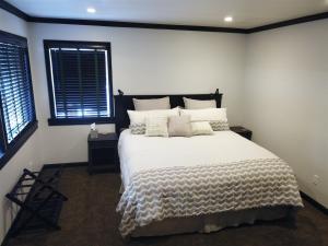 六月湖的住宿－Rr-edgewater20，一间卧室设有一张大床和两个窗户。