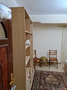 a room with a door and a table and chairs at Hello Pyramids inn in Cairo