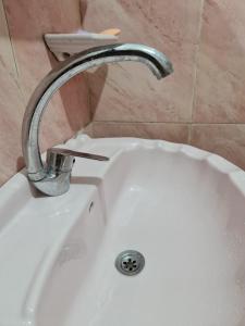 a faucet on a white sink in a bathroom at Hello Pyramids inn in Cairo