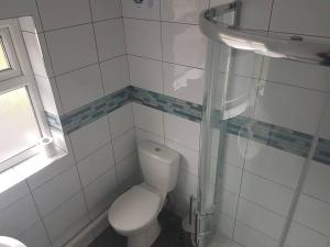 a white bathroom with a toilet and a sink at Two bedroom maisonette close toWarwick Uni in Canley
