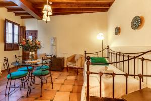 1 dormitorio con 1 cama, mesa y sillas en Charminghomesgranada Apartamento Granada Romantica en Granada