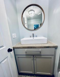 a bathroom with a sink and a mirror at Farm Charm 