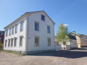a white building with windows on a street at Välrenoverad fin lägenhet i charmigt område in Söderhamn