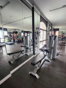 a gym with several treadmills and mirrors at Espana Condo Resort Pattaya BY MAM in Jomtien Beach