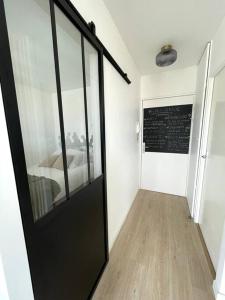 a room with a black door and a chalkboard on the wall at appartement cosy et lumineux in Orly