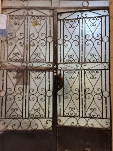 a metal door with a black knocker on it at Hello Pyramids inn in Cairo