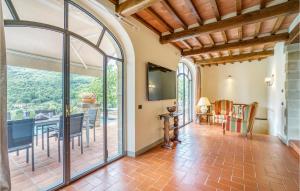 an open living room with a table and a dining room at Villa Tita in Poppi
