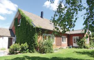 a red brick house with ivy growing on it at Stunning Home In Helsingborg With 4 Bedrooms And Wifi in Helsingborg