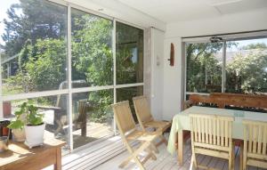 a screened in porch with a table and chairs at Stunning Home In Helsingborg With 4 Bedrooms And Wifi in Helsingborg